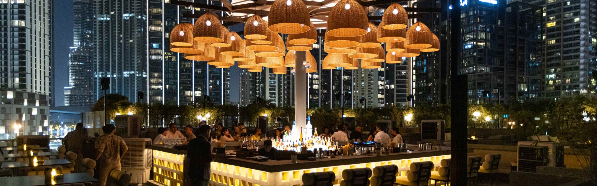 Luxurious rooftop lounge in Dubai with city skyline at night