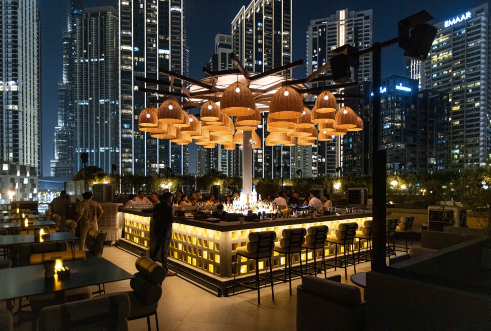 Luxurious rooftop lounge in Dubai with city skyline at night