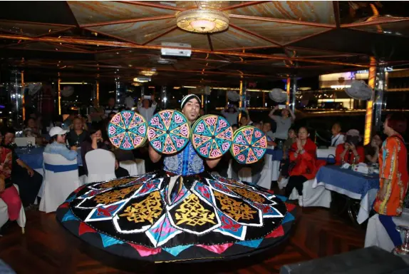 Traditional Dhow Cruise Creek during sunset in Dubai with dining setup