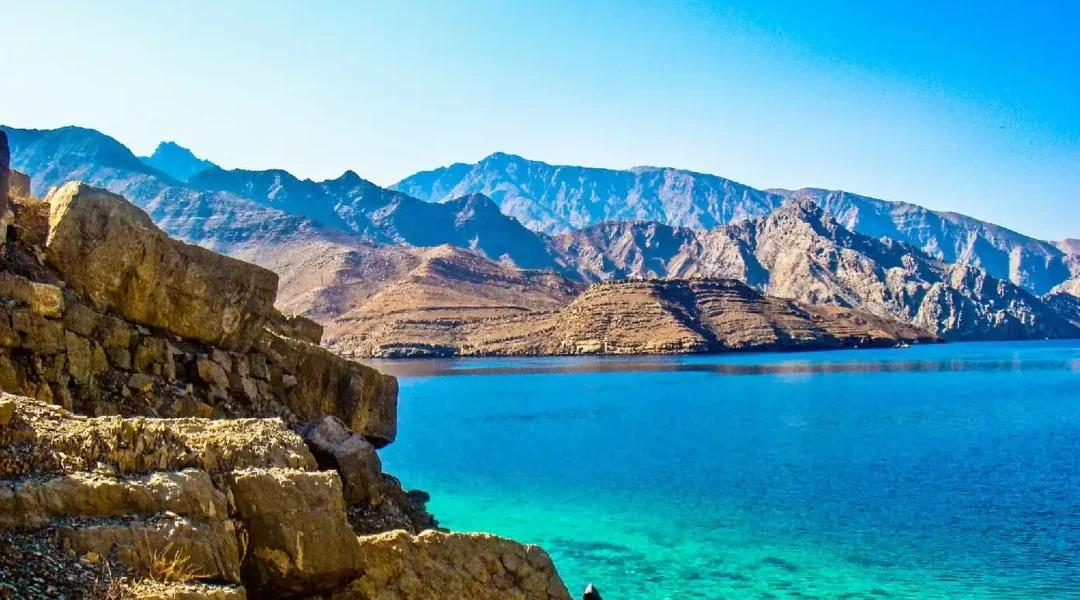 Dhow sailing through Dibba Musandam fjords under the sun – dibba musandam cruise deals