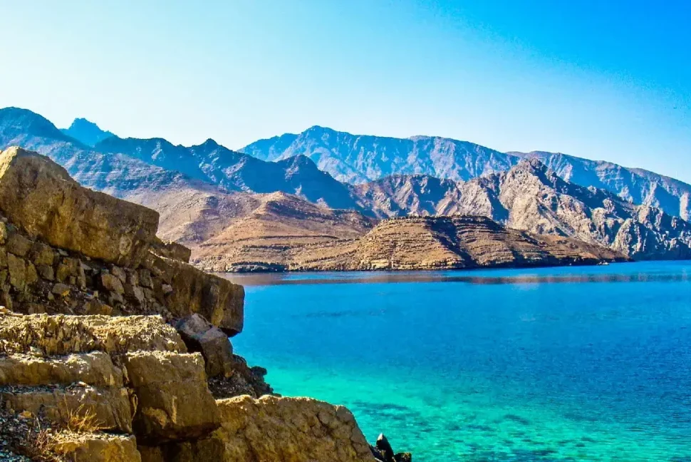 Dhow sailing through Dibba Musandam fjords under the sun – dibba musandam cruise deals