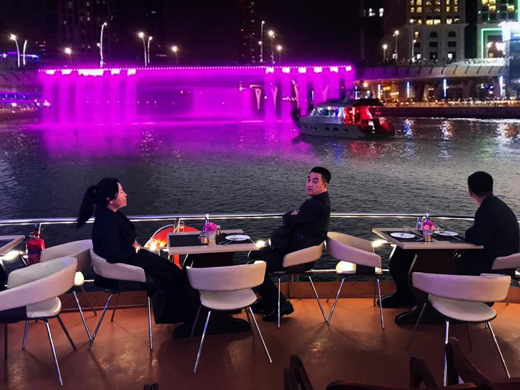 Scenic night capture of Dubai Water Canal Cruise with illuminated skyline