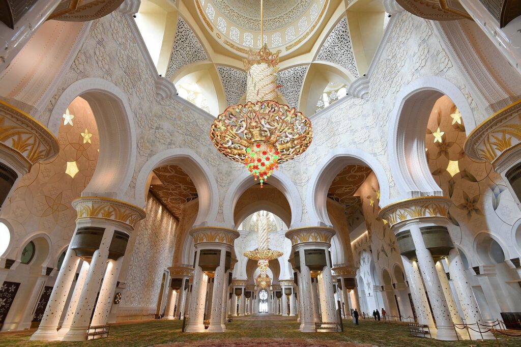 › Forever Tourism LLC Grand domes and marble courtyard at one of the top mosques to visit in the UAE