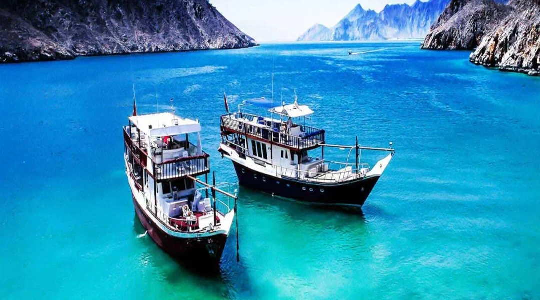 A traditional dhow sailing through Musandam Dibba majestic fjords
