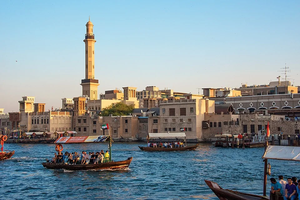 Traditional Dhow Cruise Creek during sunset in Dubai with dining setup