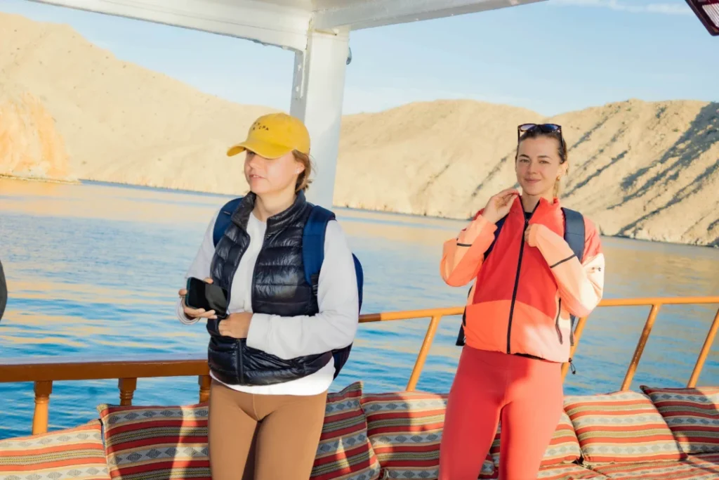 Traditional wooden dhow sailing through Musandam Dibba fjords—Musandam Dibba cruise