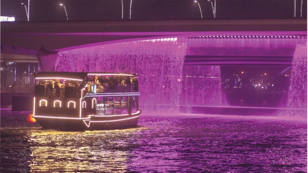 Scenic night capture of Dubai Water Canal Cruise with illuminated skyline