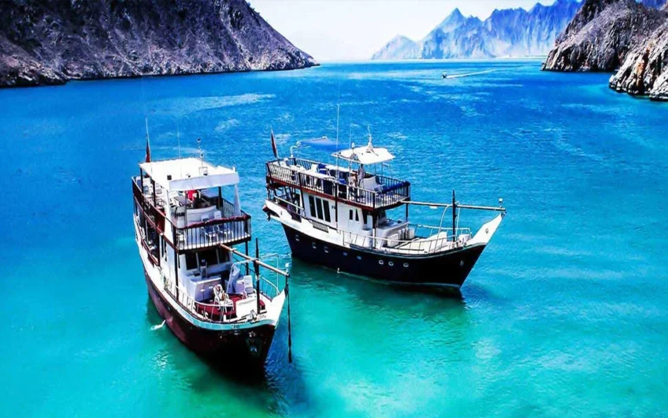 A traditional dhow sailing through Musandam Dibba majestic fjords