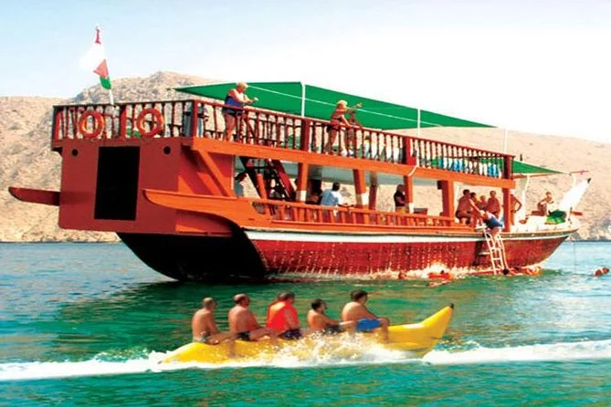 Traditional wooden dhow sailing through Musandam Dibba fjords—Musandam Dibba cruise