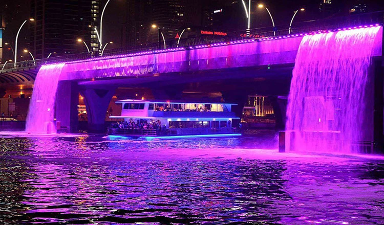 A stunning night view of Dubai Canal Cruise illuminated skyline