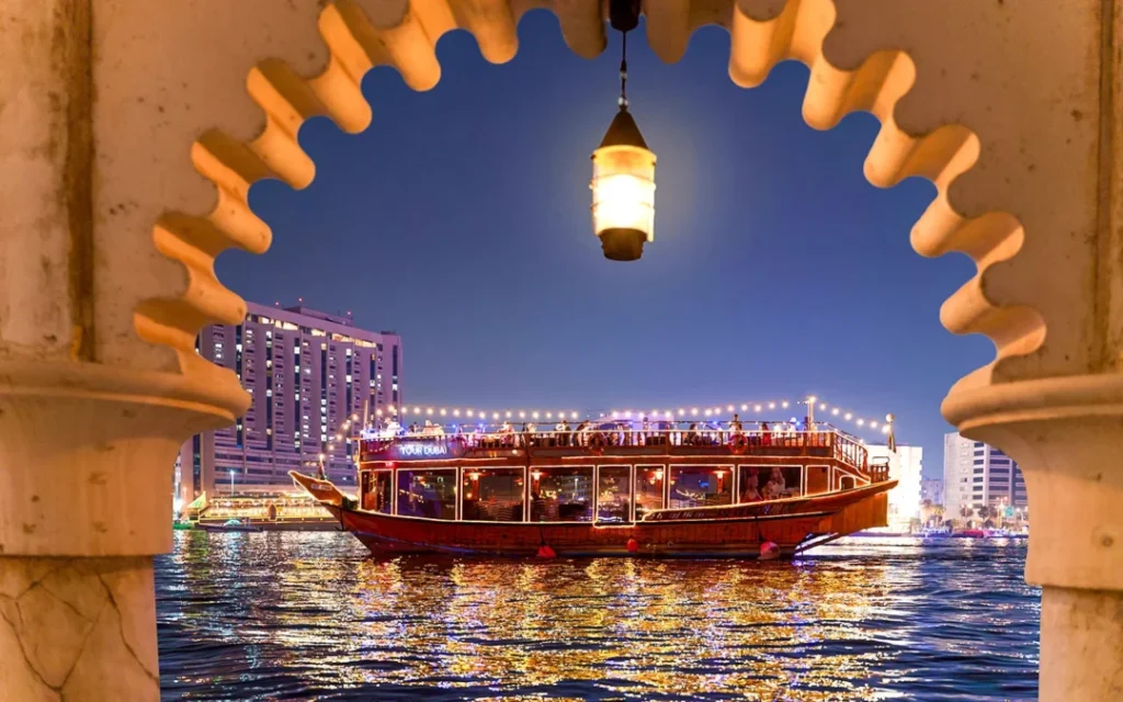 Traditional dhow cruise creek with dinner under Dubai’s evening skyline
