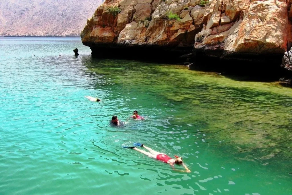 A traditional dhow sailing through Musandam Dibba majestic fjords