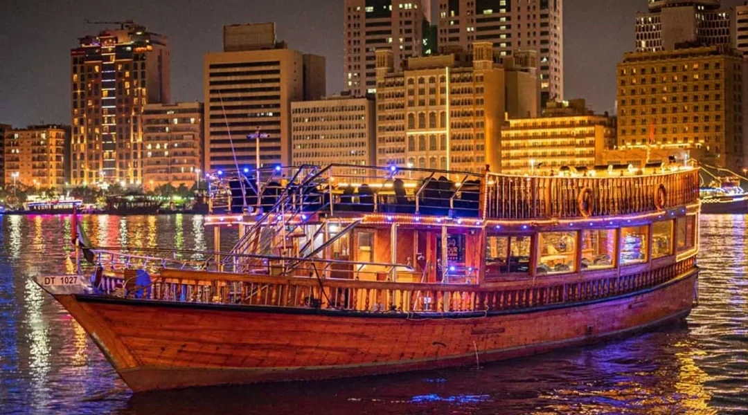 Traditional Dhow Cruise Creek during sunset in Dubai with dining setup