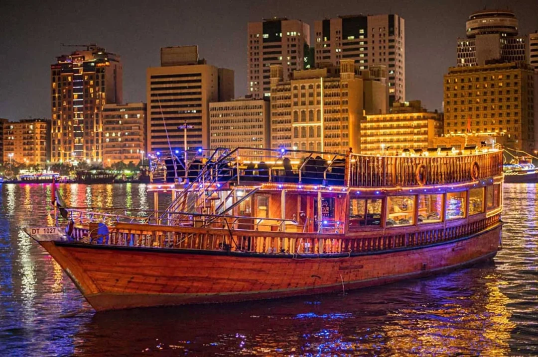 Traditional Dhow Cruise Creek during sunset in Dubai with dining setup