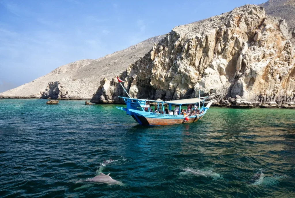 Traditional dhow sailing on crystal waters during a Musandam Dibba trip