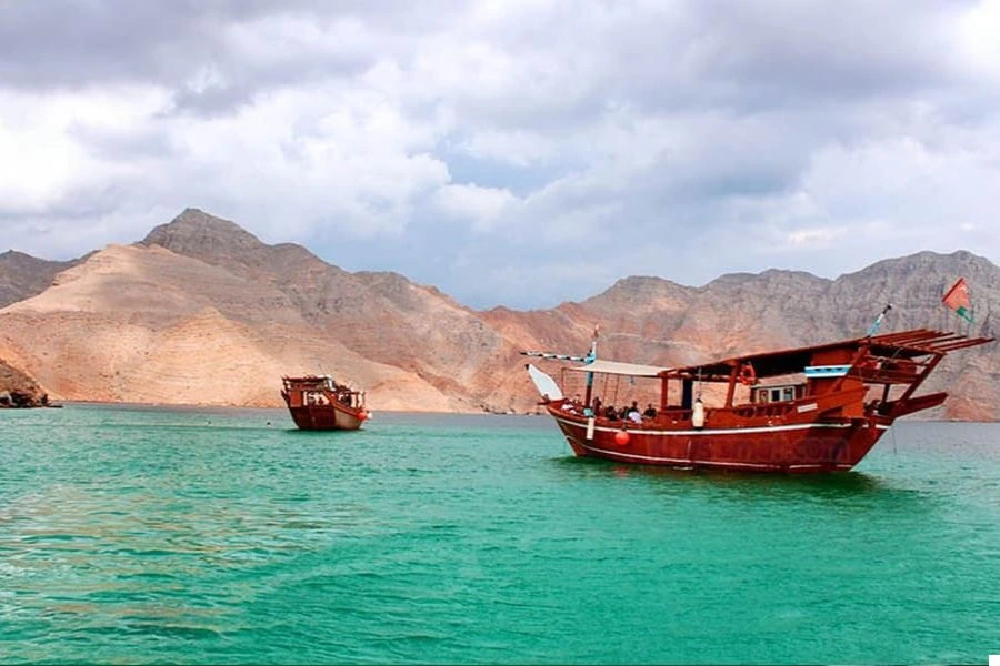 A traditional dhow sailing through Musandam Dibba majestic fjords