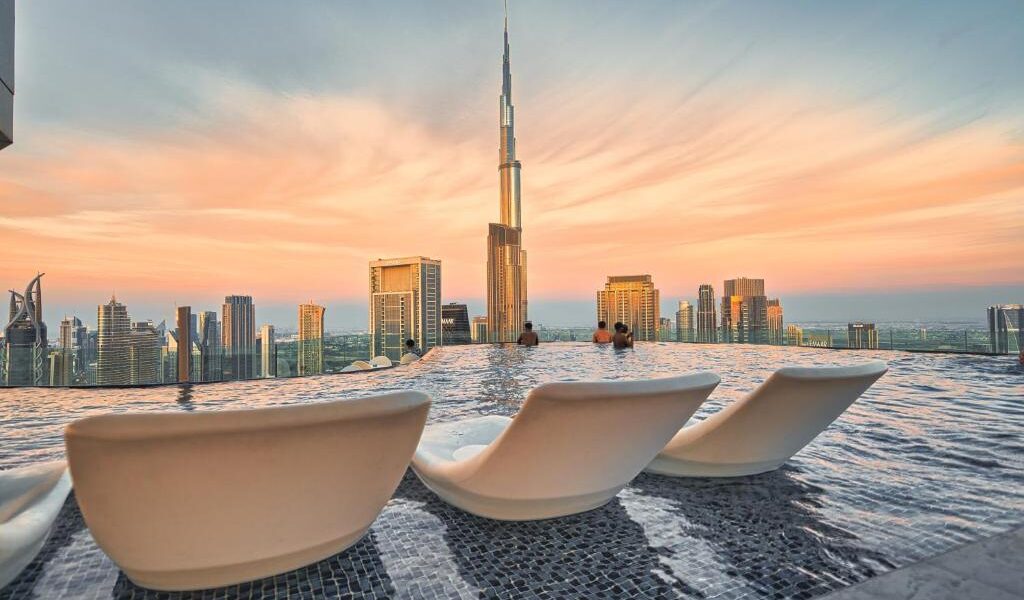 Dubai Pool Days: Luxurious poolside view at a premium Dubai resort with cabanas and skyline in the background.