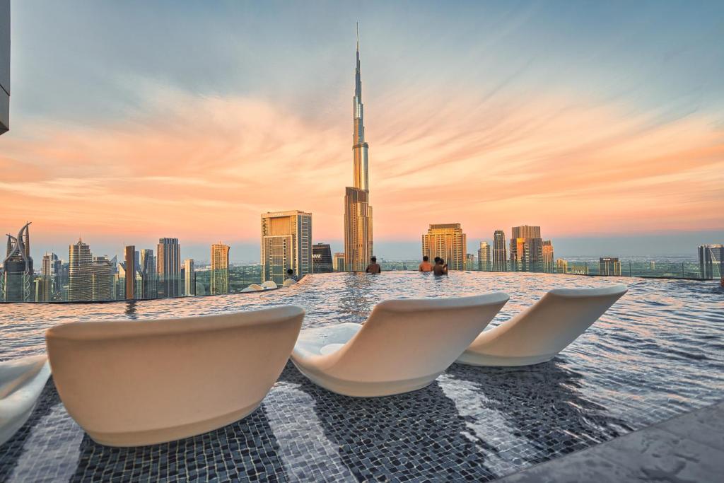 Dubai Pool Days: Luxurious poolside view at a premium Dubai resort with cabanas and skyline in the background.