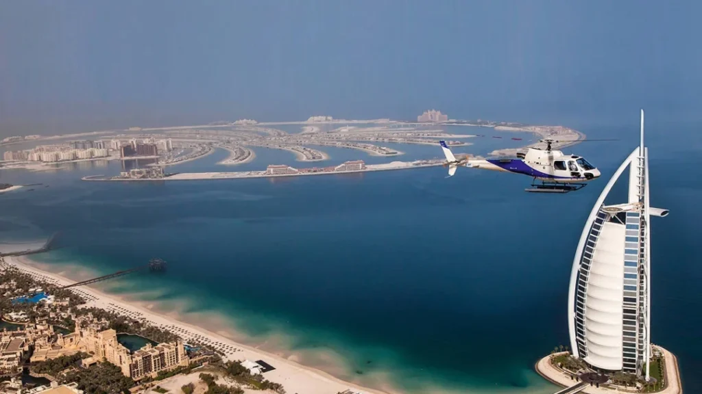 A breathtaking aerial view of Dubai’s skyline with a helicopter in Dubai flying over iconic landmarks