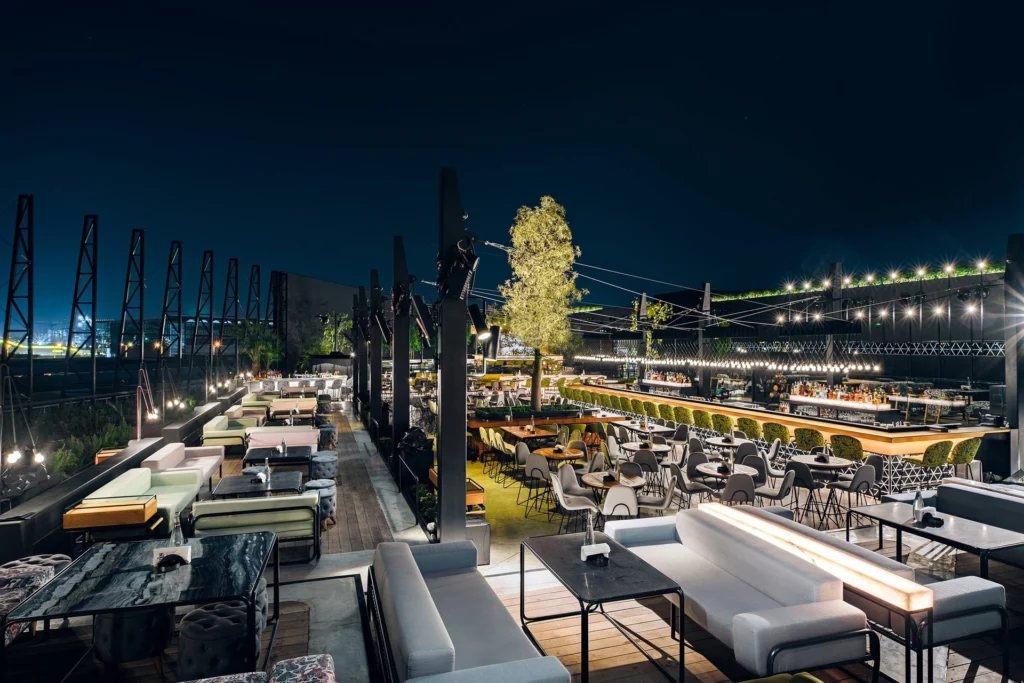 Luxurious rooftop lounges in Dubai with city skyline at night