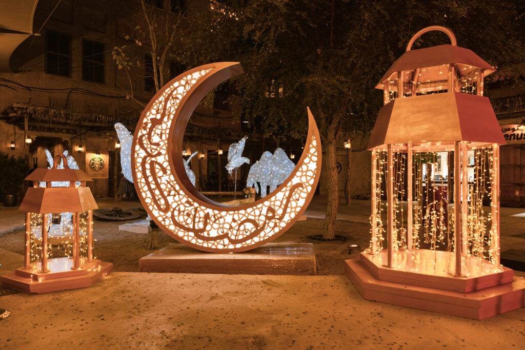 Ramadan market in Dubai at night with lanterns, food stalls, and families shopping