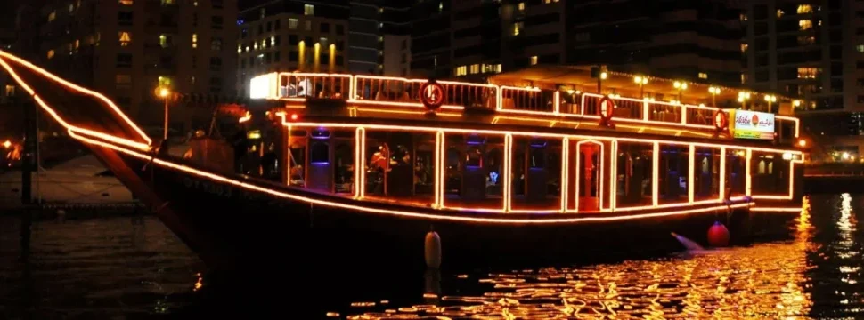 Creek Dhow Cruise during sunset with dinner setup on Dubai Creek