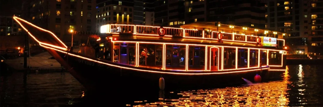 Creek Dhow Cruise during sunset with dinner setup on Dubai Creek