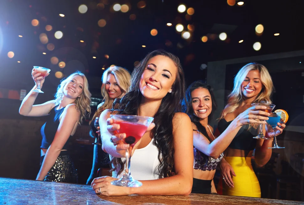 Women enjoying drinks and dancing during Thursday night ladies nights in Dubai, 2025.
