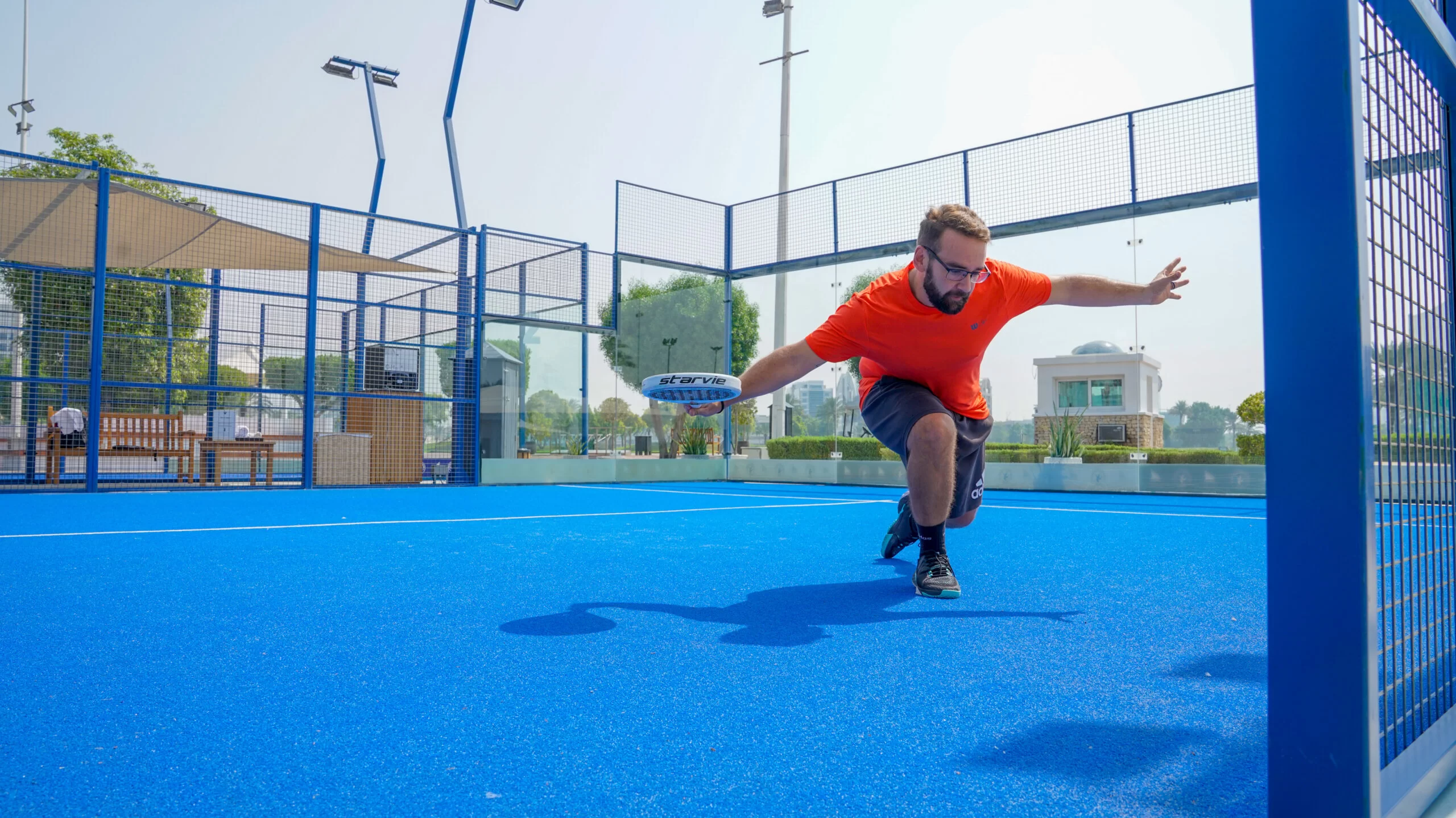Modern outdoor Padel Tennis courts in Dubai with skyline in the background