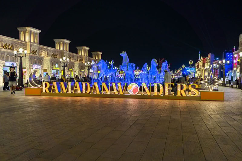 Ramadan markets in Dubai at night with lanterns, food stalls, and families shopping