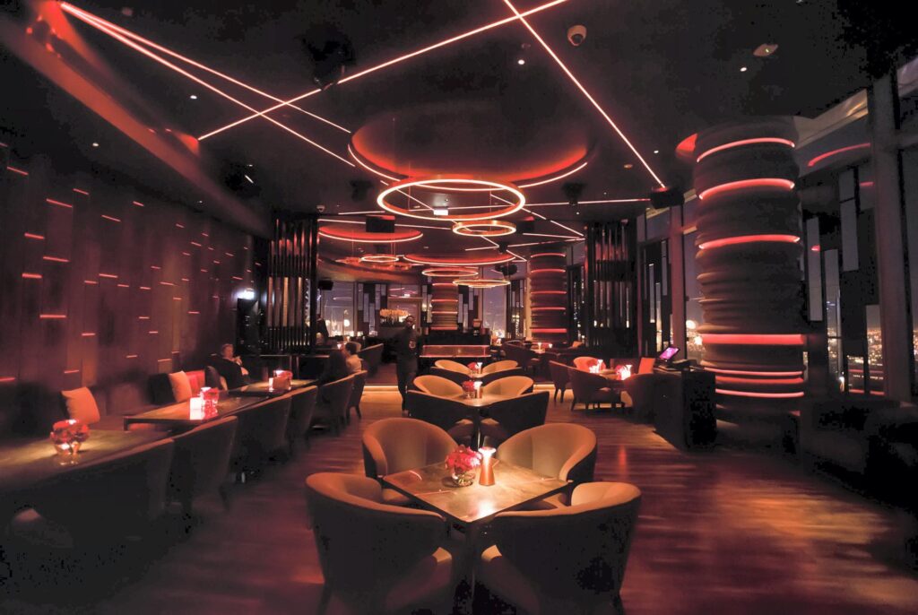 Luxurious rooftop lounges in Dubai with city skyline at night