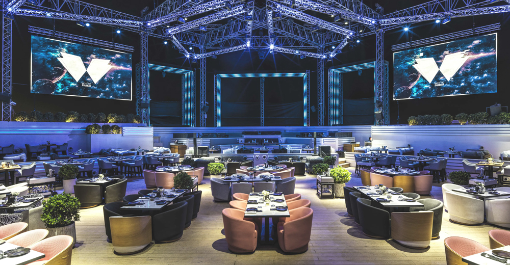 Luxurious rooftop lounges in Dubai with city skyline at night