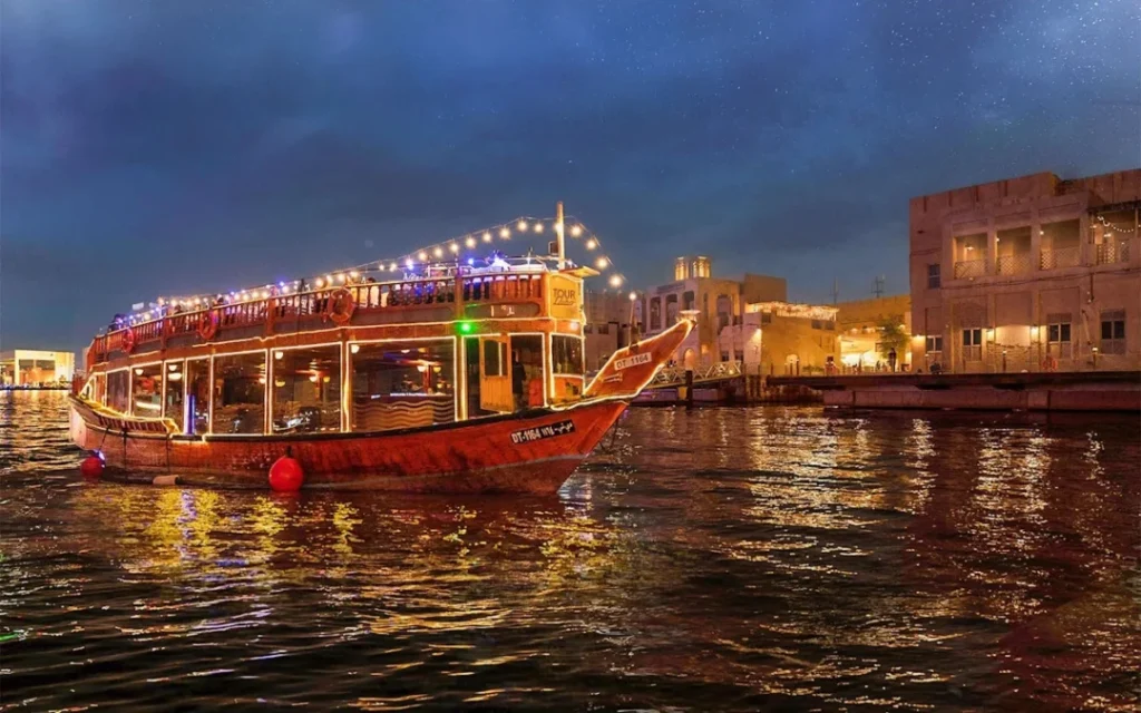 Traditional dhow cruise creek with dinner under Dubai’s evening skyline