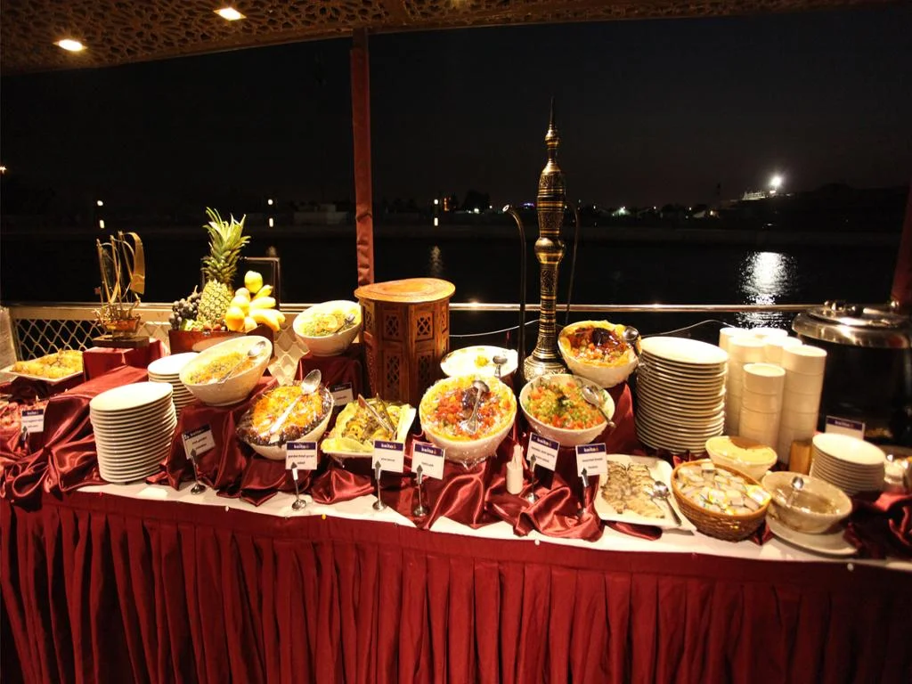 Traditional dhow cruise creek with dinner under Dubai’s evening skyline