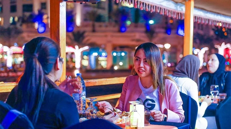 Traditional Dhow Cruise Creek during sunset in Dubai with dining setup