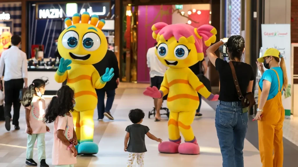 Tourists enjoying top Things to Do in Dubai in August including indoor attractions and summer activities.