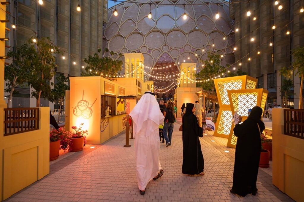 Ramadan markets in Dubai at night with lanterns, food stalls, and families shopping