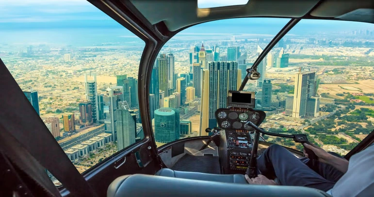 A breathtaking aerial view of Dubai’s skyline with a helicopter in Dubai flying over iconic landmarks