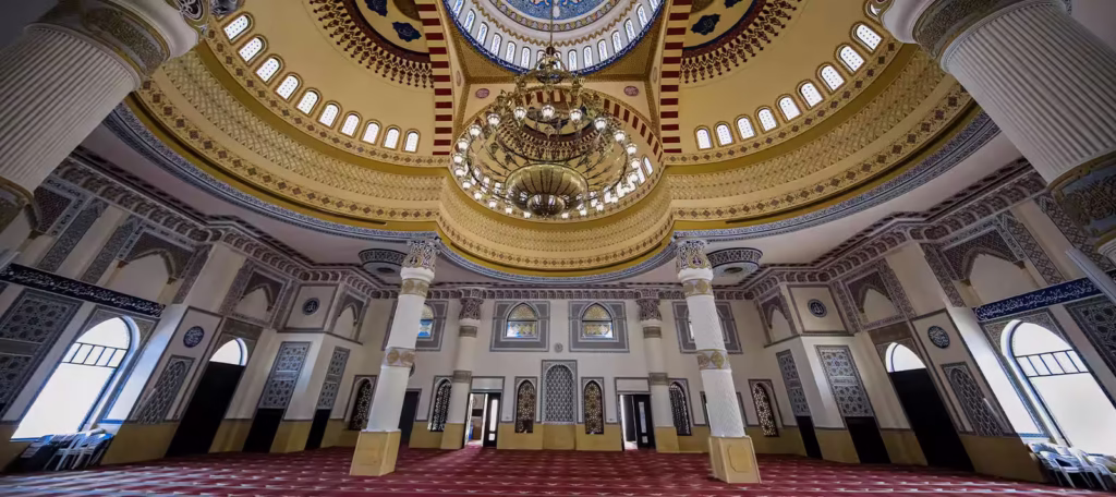 › Forever Tourism LLC Grand domes and marble courtyard at one of the top mosques to visit in the UAE