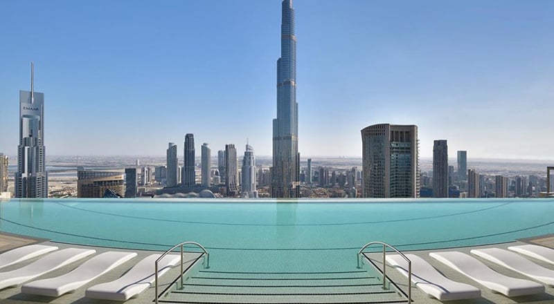Luxurious poolside view at a premium Dubai resort with cabanas and skyline in the background
