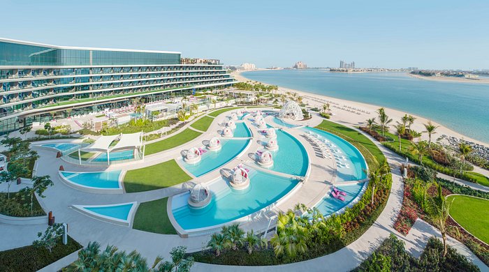 Luxurious poolside view at a premium Dubai resort with cabanas and skyline in the background