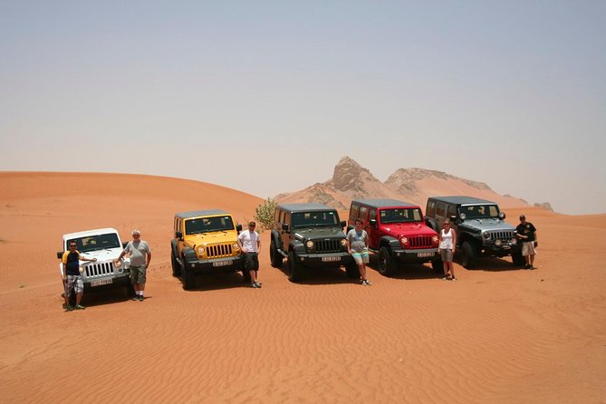 desert safari tours reviews guide with red dunes, 4x4 convoy, and camp lights