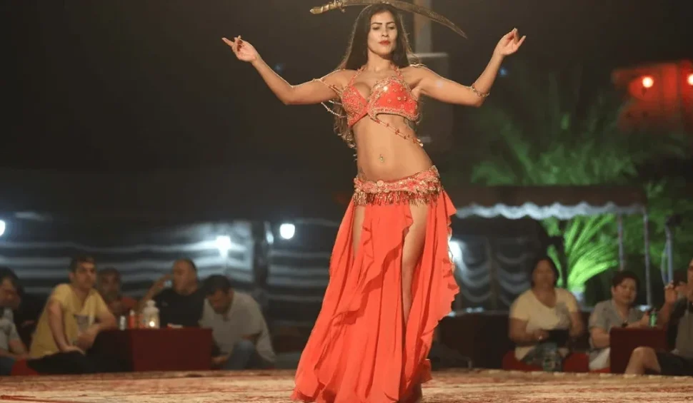 Belly dance desert safari Dubai experience with 4x4 dune bashing, sandboarding, and traditional evening entertainment under the stars