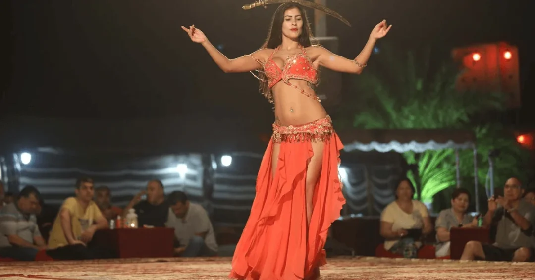 Belly dance desert safari Dubai experience with 4x4 dune bashing, sandboarding, and traditional evening entertainment under the stars