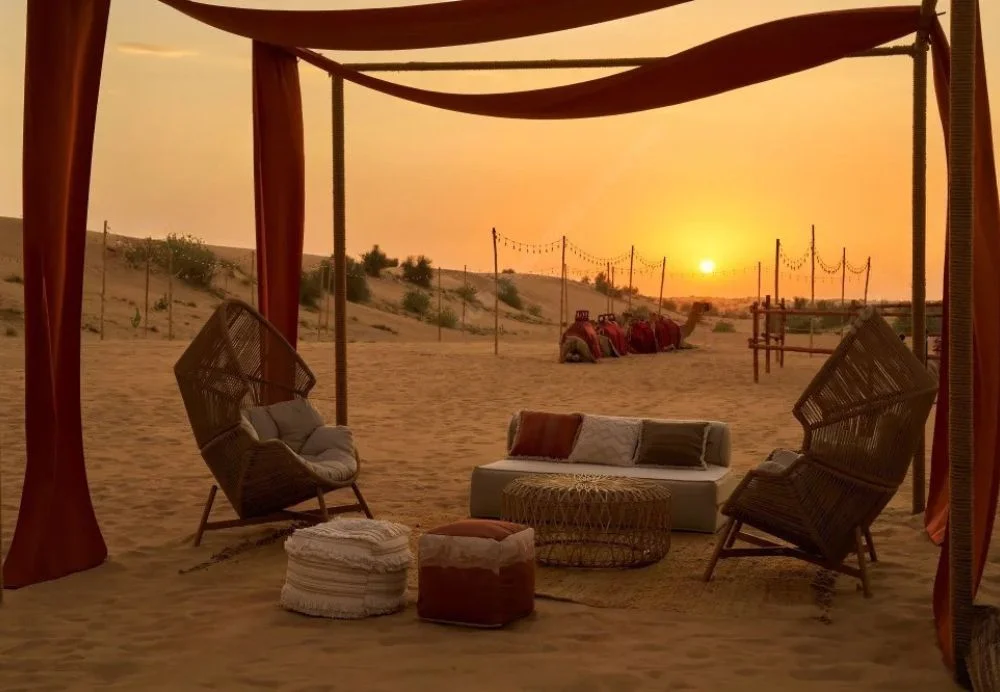 Sunday night Dubai desert safari with red dunes, camel ride, and camp lights