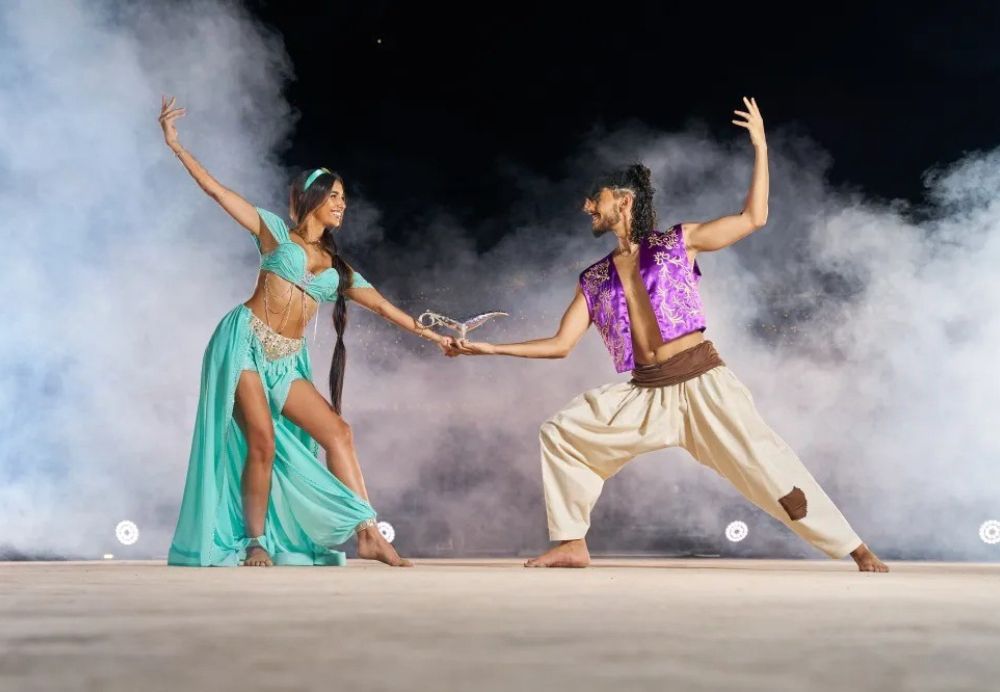 Cultural Show at Unique Desert Safari Camp Dubai › Forever Tourism LLC Arabic performers dancing under desert lights during a unique desert safari camp cultural evening in Dubai.