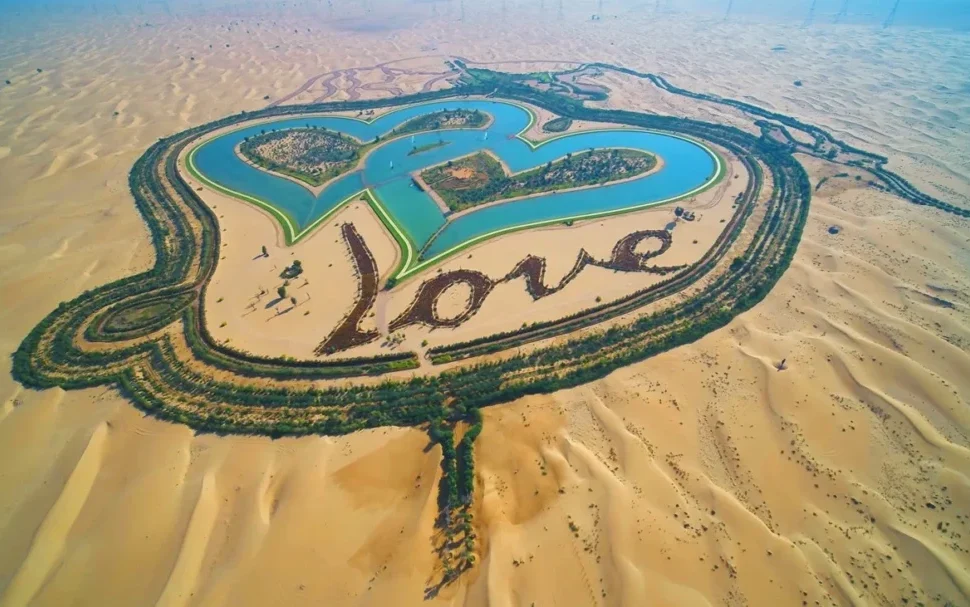 Dubai Desert Safari Location | Best Area, Drive Times & Tips › Forever Tourism LLC A panoramic view of a popular Dubai Desert Safari location with 4x4 vehicles, sand dunes, and traditional Bedouin camp setup.