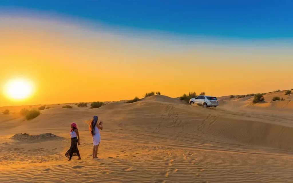 4×4 cresting red dunes at sunset during a desert tour Dubai
