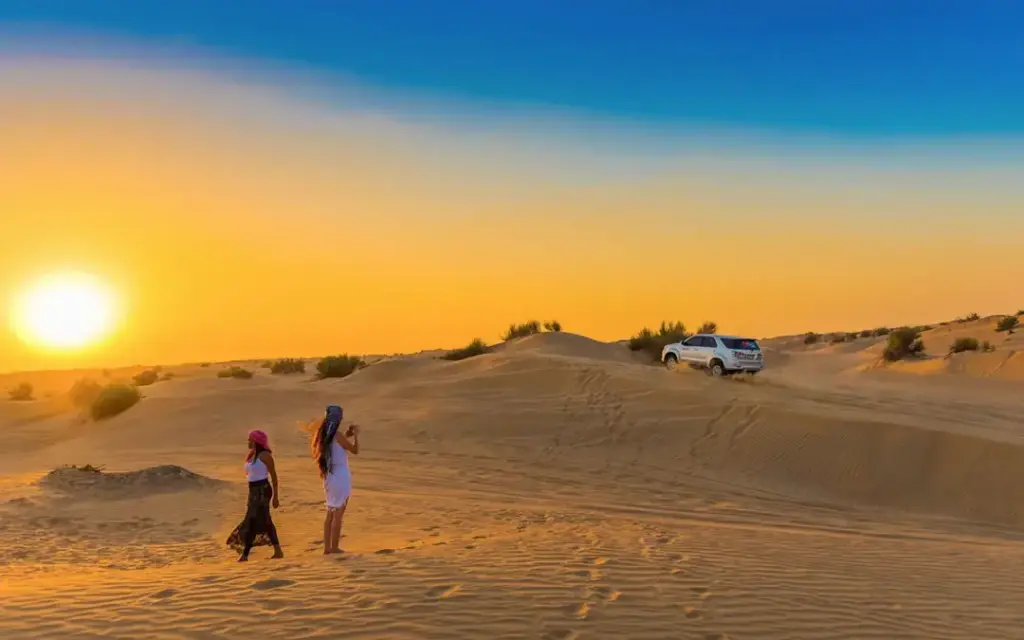 › Forever Tourism LLC 4x4 SUV racing through desert dunes at sunset, representing thrilling experiences and Dune Bashing Dubai cost for tourists
