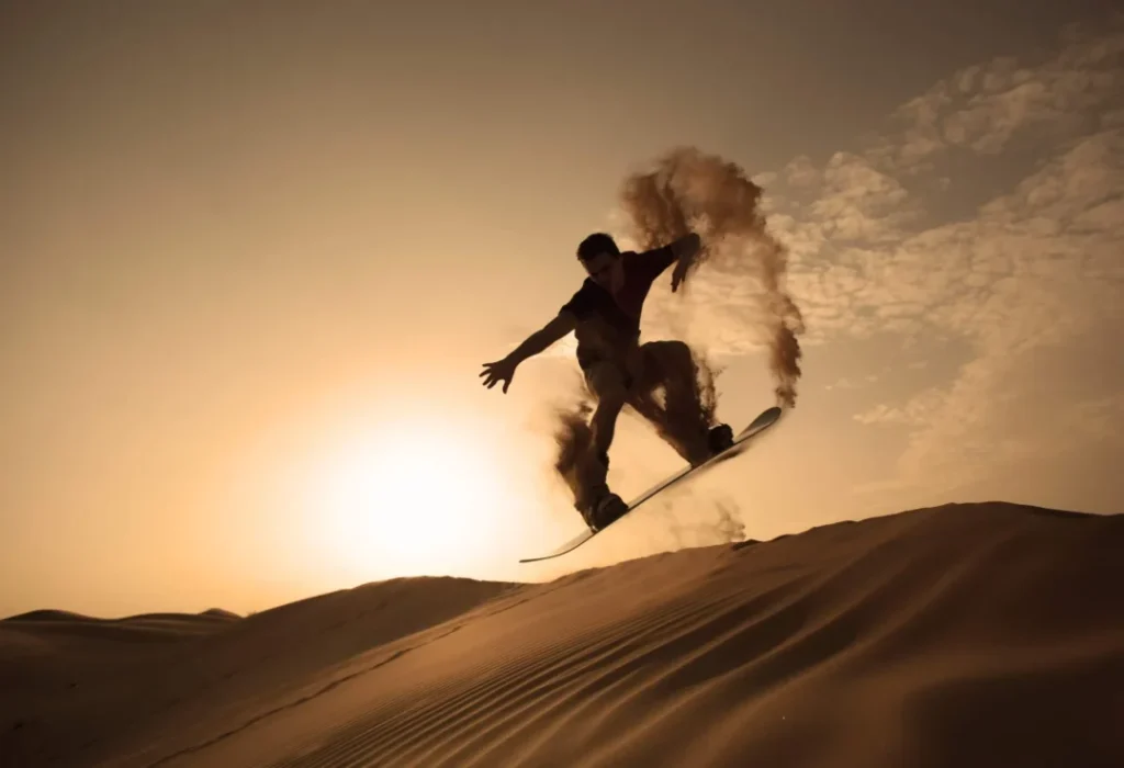 Tourist taking Desert Safari Dubai pictures during golden hour